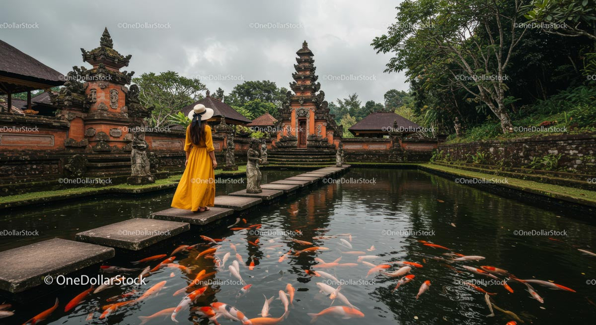 Woman in Yellow Dress at Balinese Temple with Koi Pond