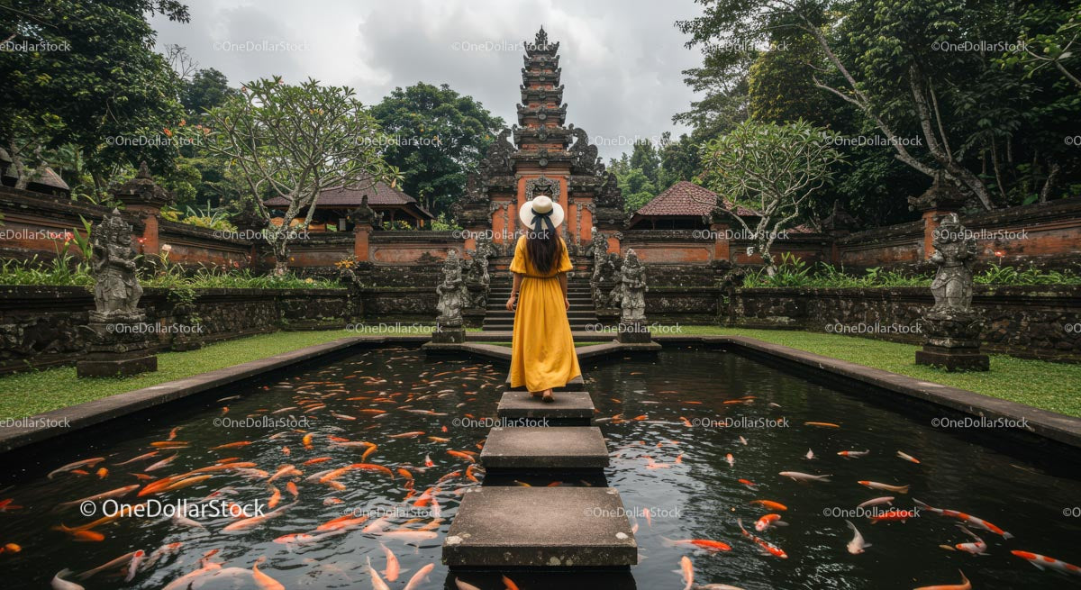 Woman in Yellow Dress at Balinese Temple with Koi Pond