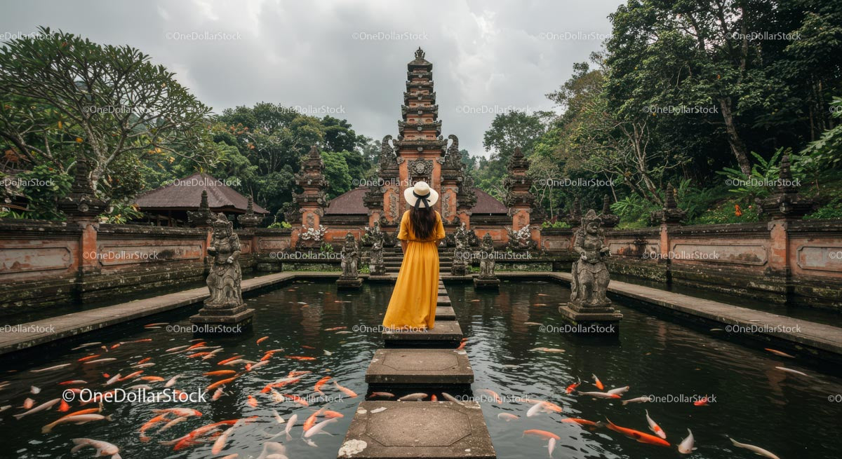 Woman in Yellow Dress at Balinese Temple with Koi Pond