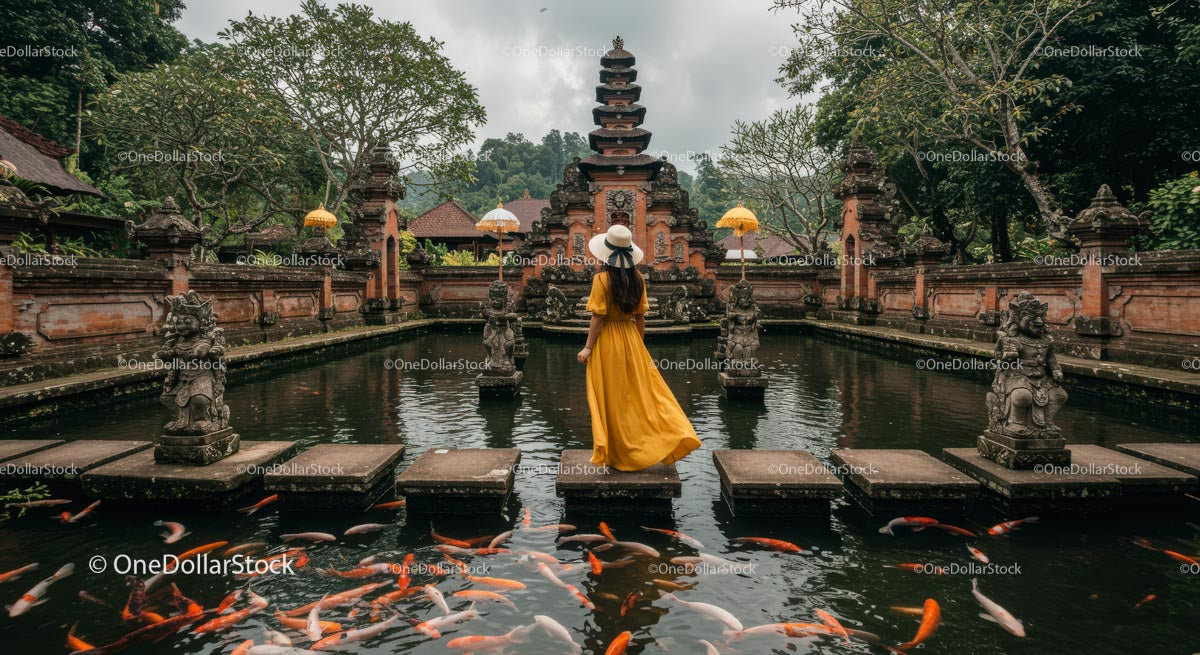 Woman in Yellow Dress at Balinese Temple Pond