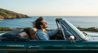 Man Driving Convertible Car Along Scenic Coastline