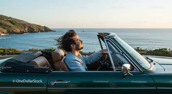 Man Driving Convertible Car Along Scenic Coastline