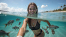 Smiling Woman Snorkeling with Tropical Fish in Clear Ocean