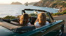 Friends on a Coastal Road Trip in Convertible Car