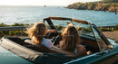 Friends on a Coastal Road Trip in Convertible Car