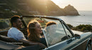 Friends on a Coastal Road Trip in Convertible Car