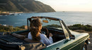Friends on a Coastal Road Trip in Convertible Car