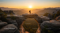 Hiker on Arch at Sunset in Scenic Mountain Landscape