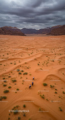 Horseback Riders Traversing Majestic Desert Dunes