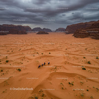 Horse Riders Crossing Majestic Desert Landscape