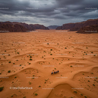 Riders Journeying Across Dramatic Desert Landscape