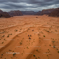 Horseback Adventurers Traversing Vast Desert Dunes