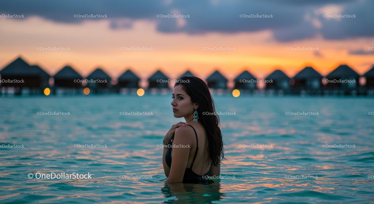 Woman Enjoying a Tropical Sunset in Ocean Waters