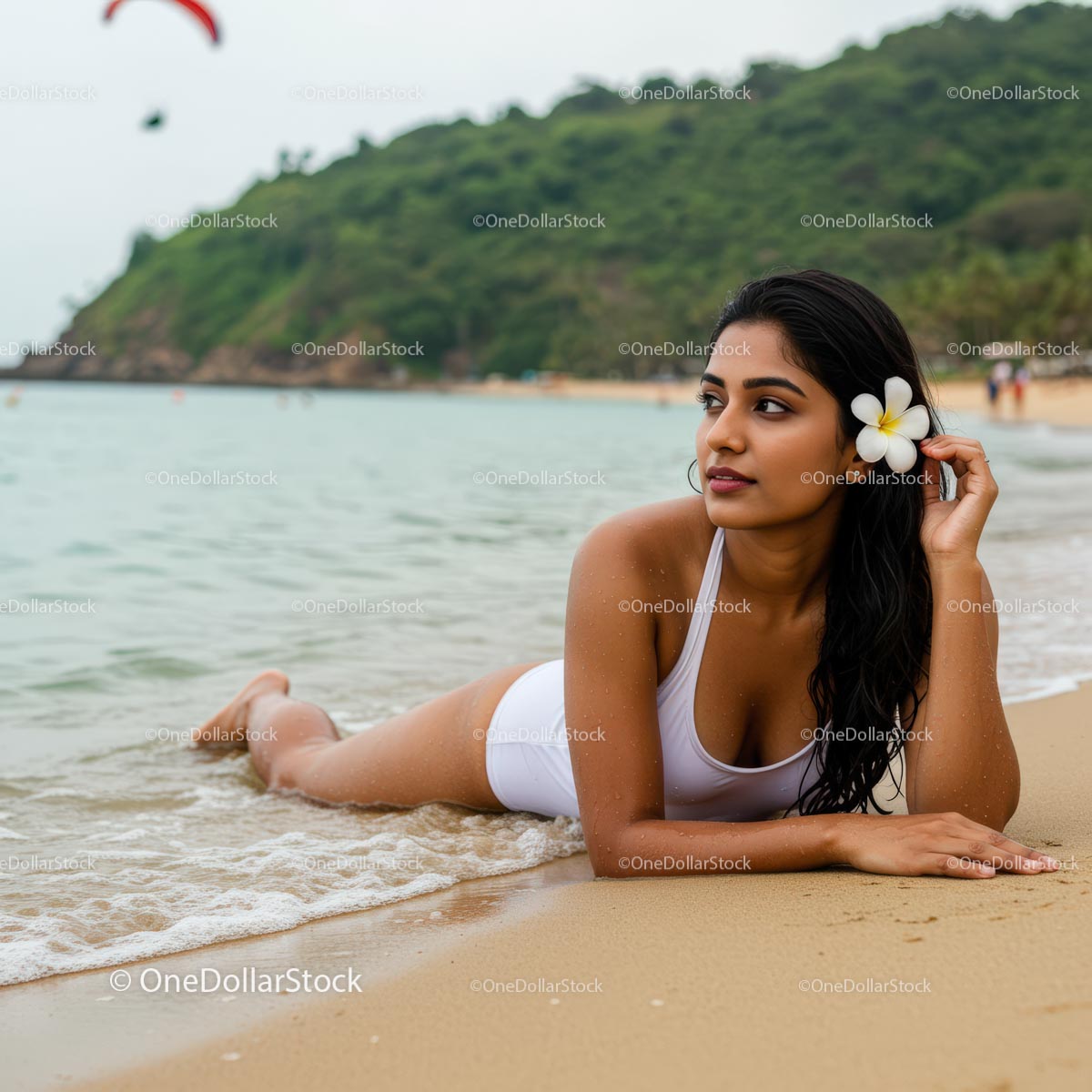 Woman Relaxing on a Tropical Beach with a White Frangipani