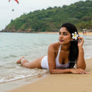 Woman Relaxing on a Tropical Beach with a White Frangipani