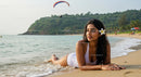 Woman Relaxing on Tropical Beach with Frangipani