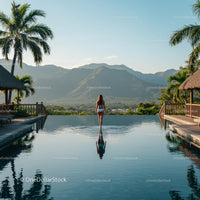 Infinity Pool with Mountain and Palm Tree View at Sunrise