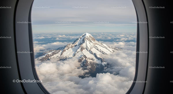 Snow-Capped Mountain View from Airplane Window