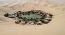 Stunning Desert Oasis Surrounded by Endless Sand Dunes
