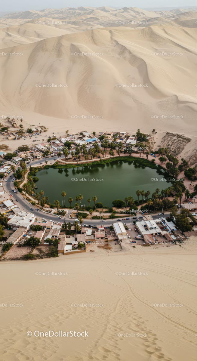 Aerial View of Huacachina Oasis Surrounded by Sand Dunes
