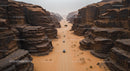 Off-Road Convoy Journeying Through Majestic Desert Canyon