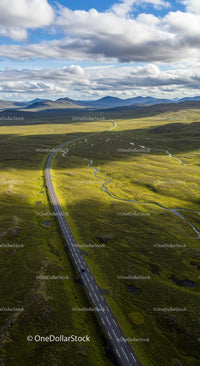 Aerial View of Scenic Road Through Green Landscape