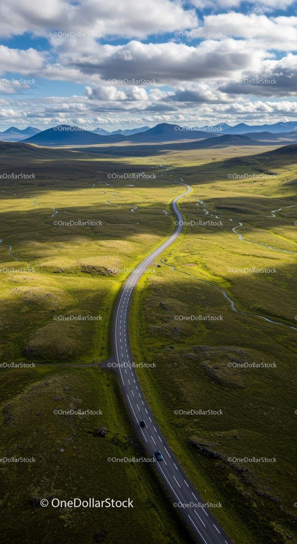 Winding Road Through Expansive Green Hills and Dramatic Sky