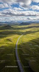Winding Road Through Verdant Hills Under Dramatic Skies