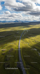 Scenic Aerial View of Winding Road Through Green Hills