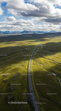 Scenic Aerial View of Winding Road Through Green Hills