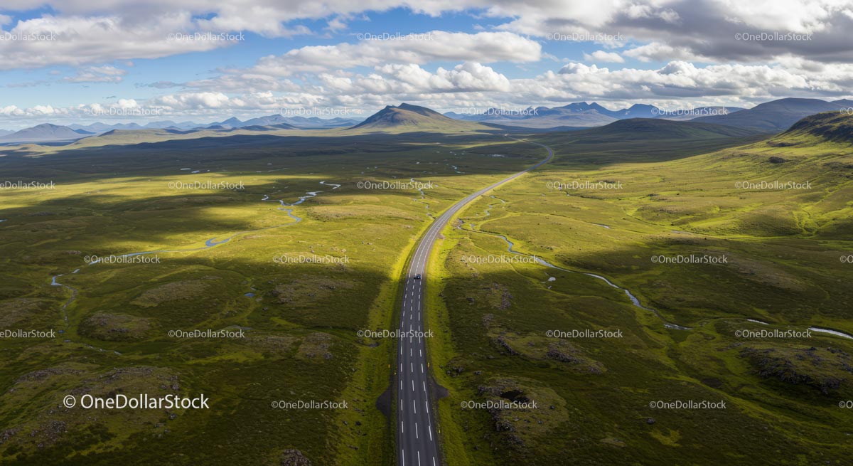Scenic Road Through Vast Landscape with Rolling Hills