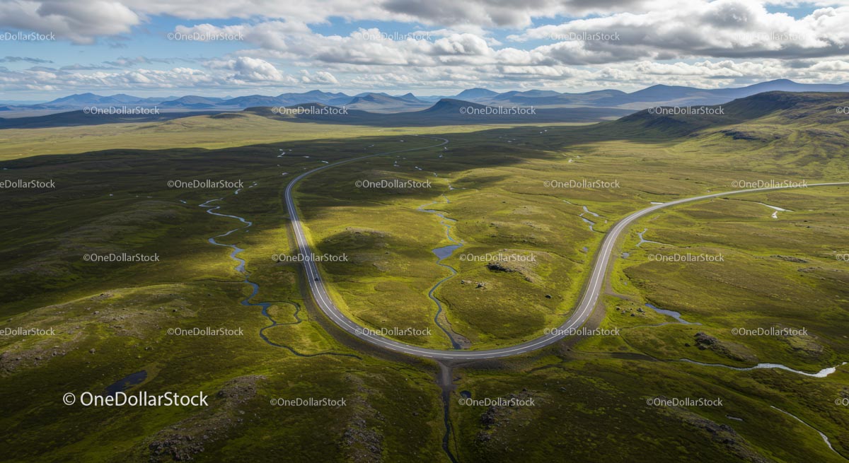 Scenic Aerial View of Winding Road Through Green Landscape