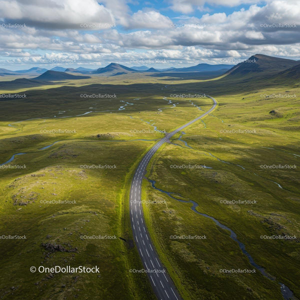 Aerial View of a Scenic Winding Road Through Green Hills