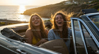 Two Women Driving Vintage Convertible by Ocean