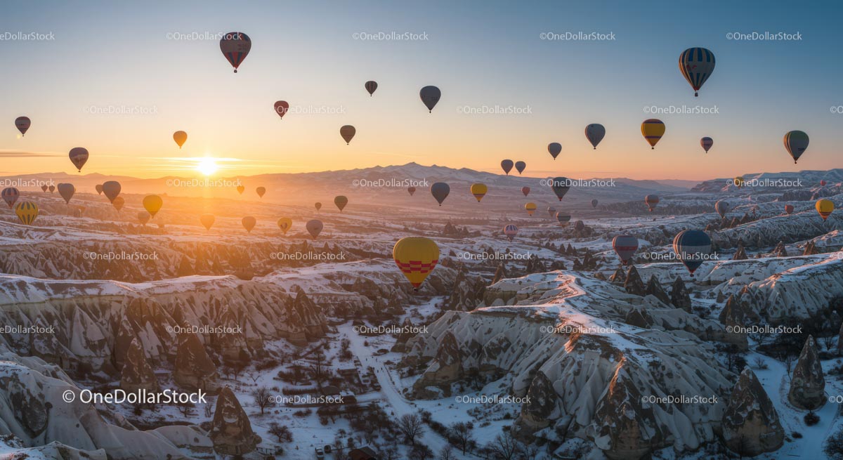 Hot Air Balloons at Sunrise Over Snowy Cappadocia