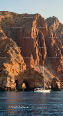 Sailing Yacht by Dramatic Red Cliffs at Sunset