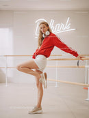 Young Woman in Red Jacket Posing in Dance Studio