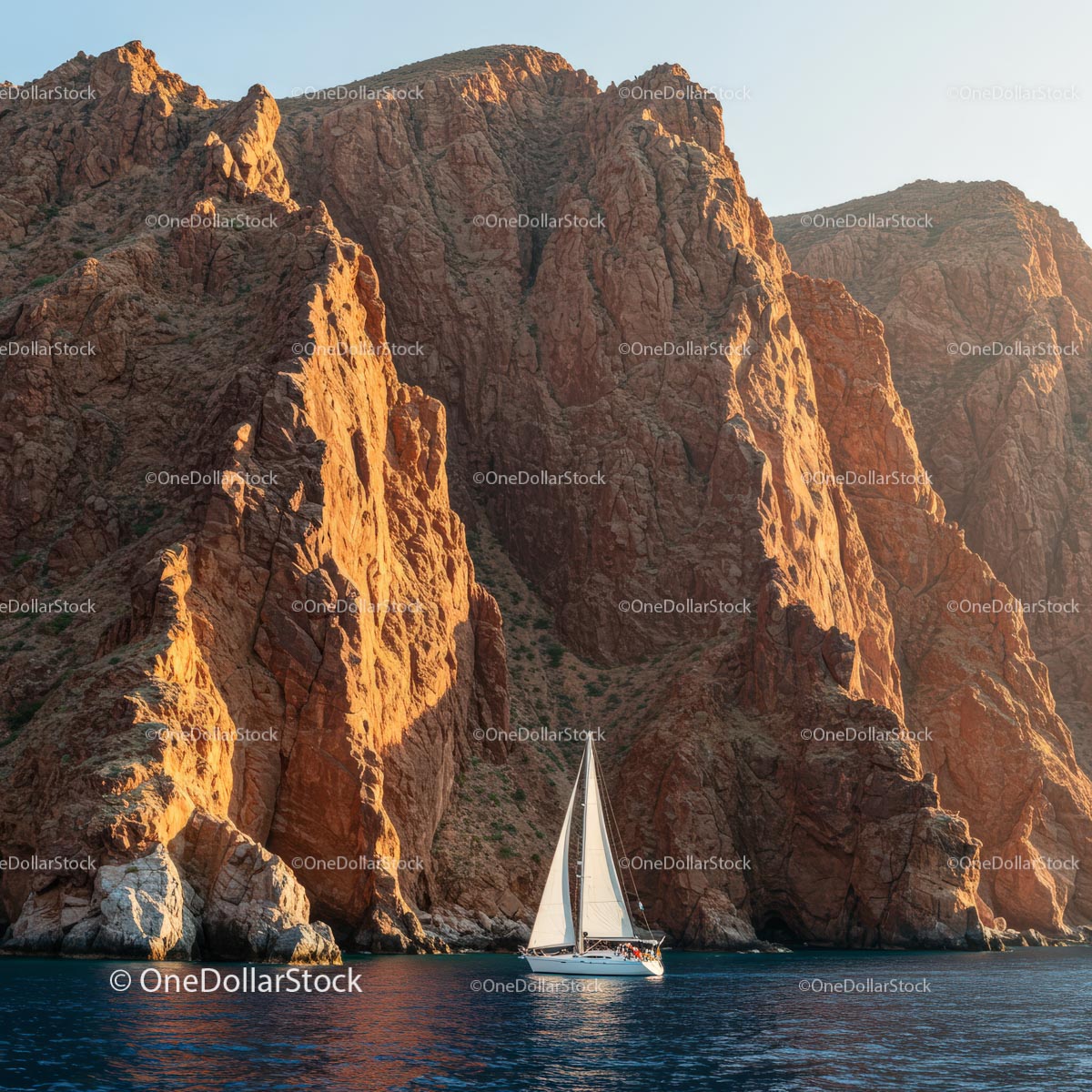 Sailboat Navigating Majestic Cliffs at Sunset
