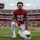 American Football Player Kneeling in Stadium