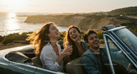 Two Women Driving Vintage Convertible by Ocean
