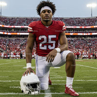 American Football Player Kneeling on Grass Field
