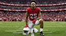 American Football Player Kneeling on Field in Red Jersey