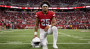 Football Player Kneeling on Field in Red Jersey
