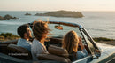 Two Women Driving Vintage Convertible by Ocean