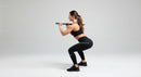 Athletic Woman Performing Squats with Barbell