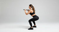 Athletic Woman Performing Squats with Barbell