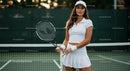 Female Tennis Player in White Outfit on Outdoor Court
