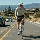 Man Cycling on Scenic Mountain Road on a Sunny Day