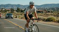 Cyclist on Scenic Road During Sunny Day Workout