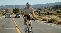 Cyclist Riding on Scenic Mountain Road in Sunny Weather